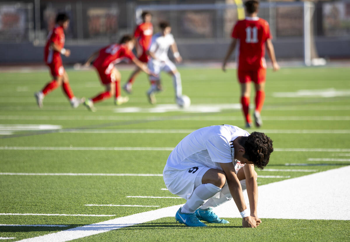 Las Vegas High junior Jonathan Avina (9) squats down after being injured during the high school ...