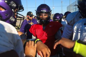 Quarterback Alexander Mercurius speaks with teammates during a huddle at football practice at D ...