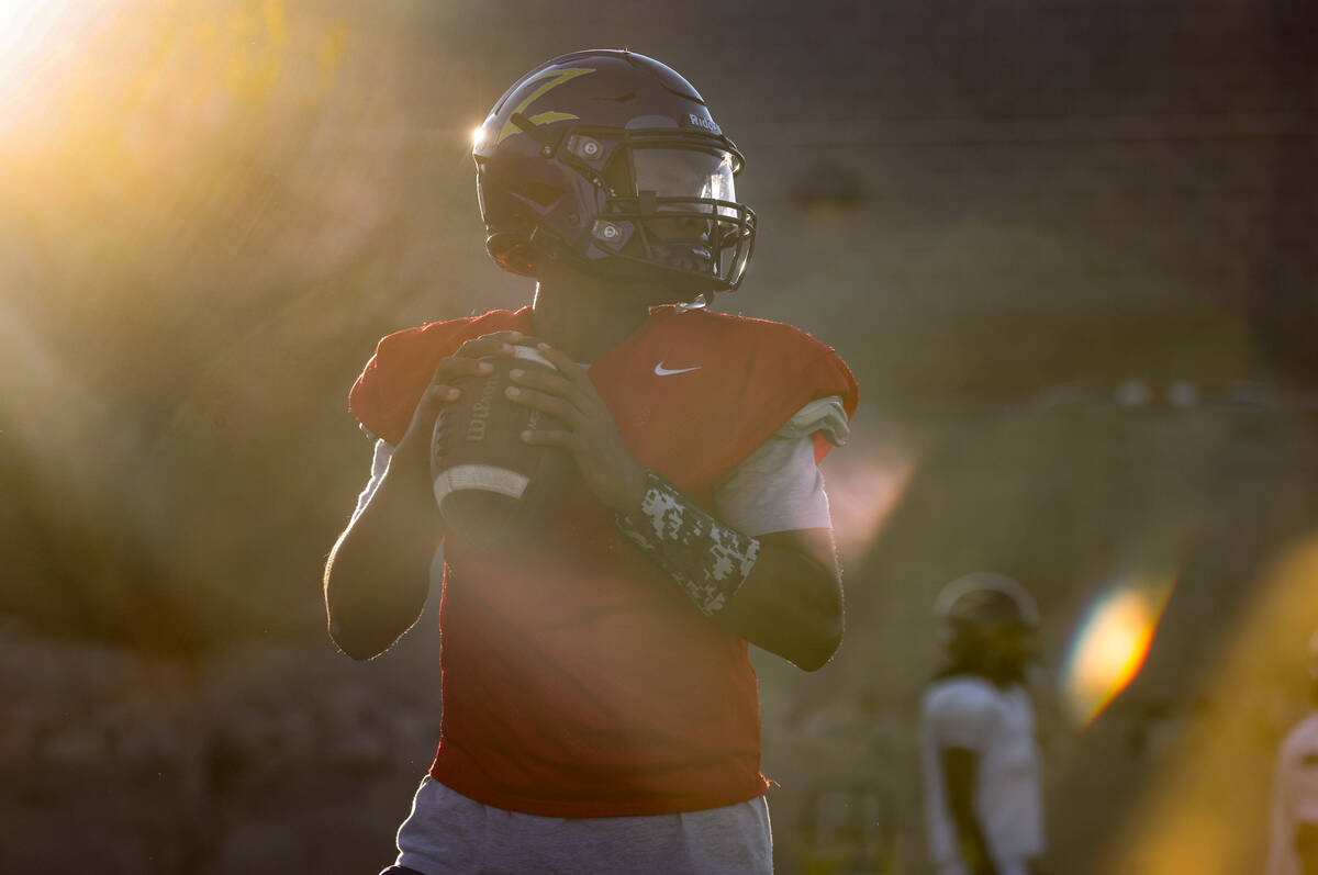 Quarterback Alexander Mercurius winds up to throw the ball during football practice at Durango ...