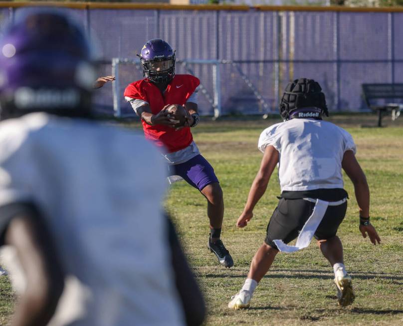 Quarterback Alexander Mercurius catches the ball during football practice at Durango High Schoo ...