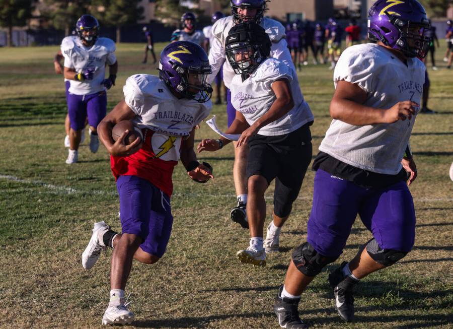 Running back Makai Miller runs with the ball during football practice at Durango High School in ...