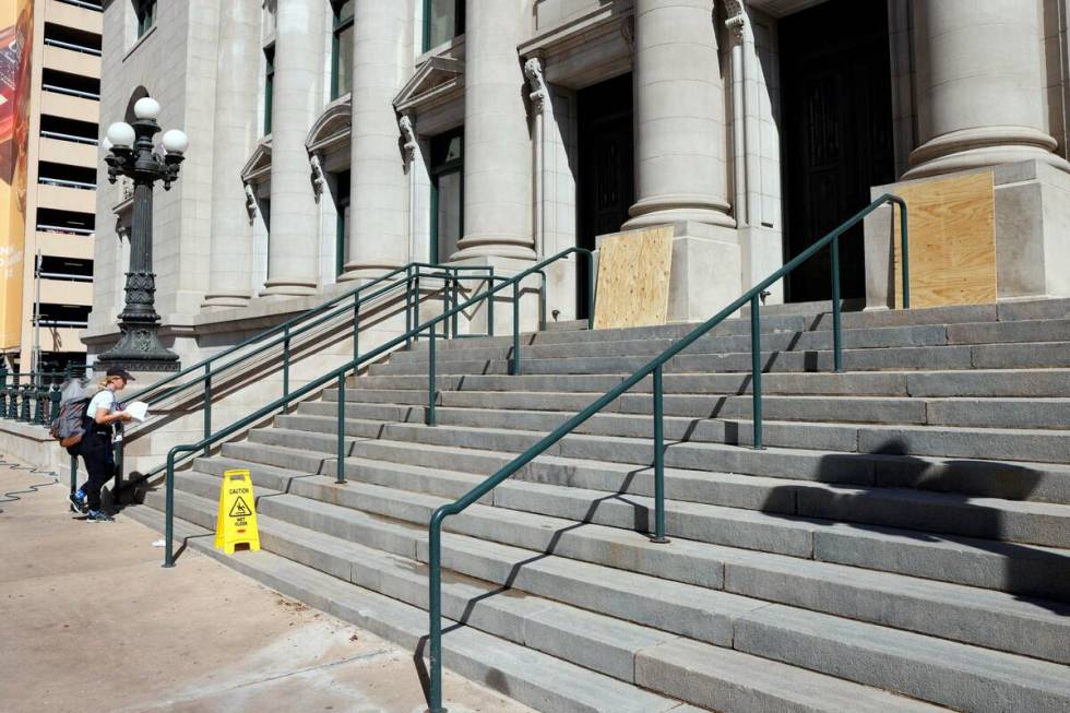 Plywood covers the base of columns that were graffitied at the entrance to the UNT Dallas Colle ...