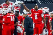 UNLV quarterback Hajj-Malik Williams (6) cheers for his defense while pumping up the crowd agai ...