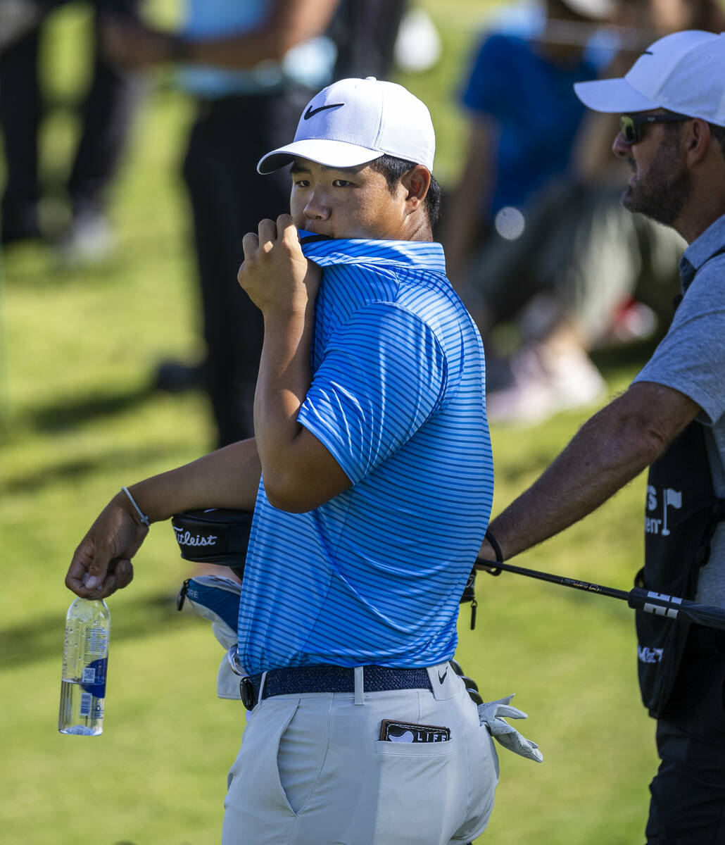 Tom Kim looks on to other players at hole #6 during the opening round of the Shriners Children' ...