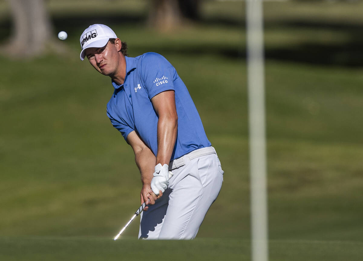 Maverick McNealy chips a shot onto the green at hole #18 during the opening round of the Shrine ...