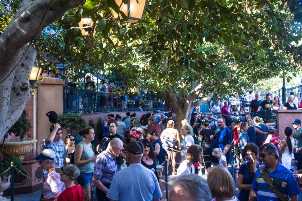 Disneyland teems with visitors in Anaheim, California, shown here waiting in a long line for th ...