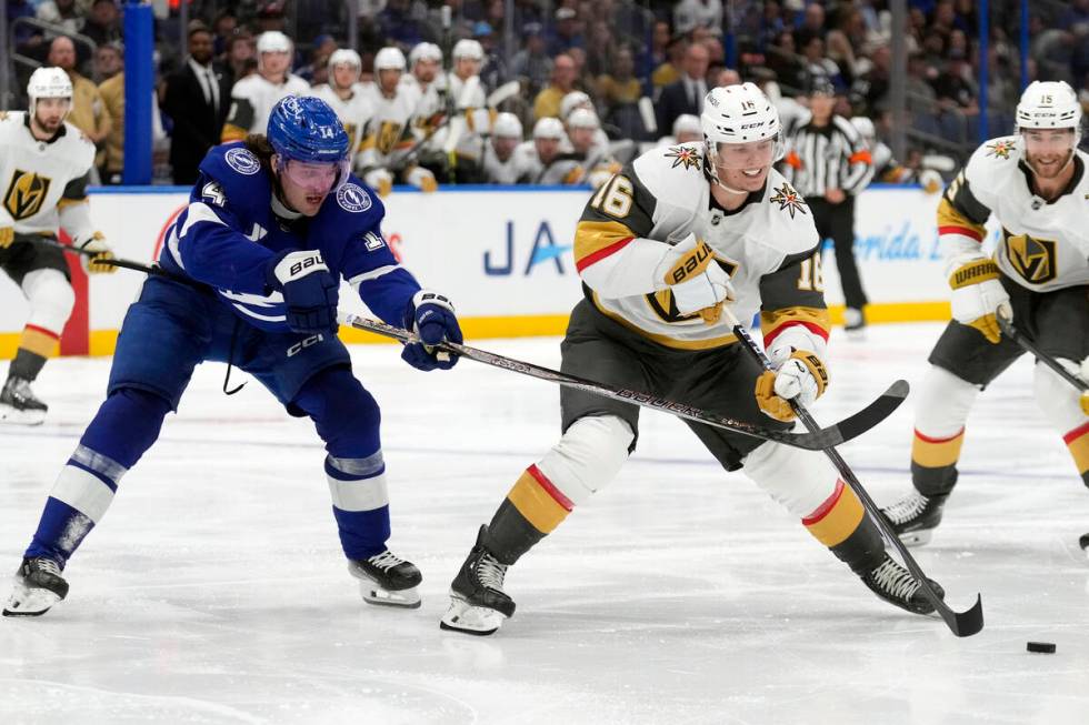 Tampa Bay Lightning center Conor Geekie (14) hooks Vegas Golden Knights left wing Pavel Dorofey ...