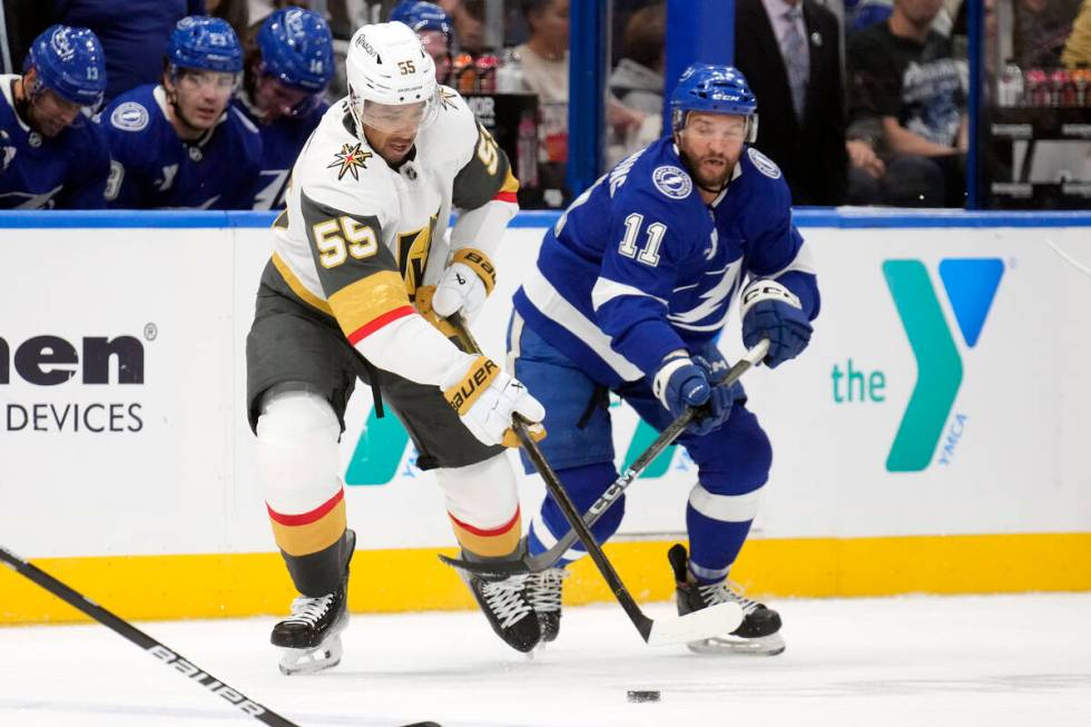 Vegas Golden Knights right wing Keegan Kolesar (55) steals the puck from Tampa Bay Lightning ce ...