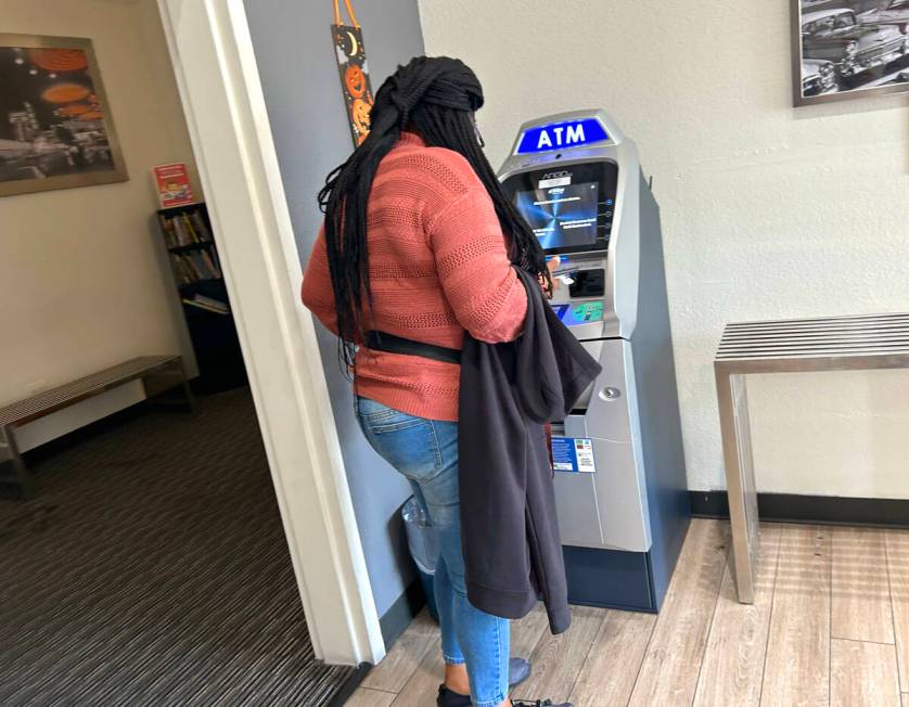 An unidentified customer prepares to use an ATM at the lobby of Siegel Suites on Flamingo Boule ...