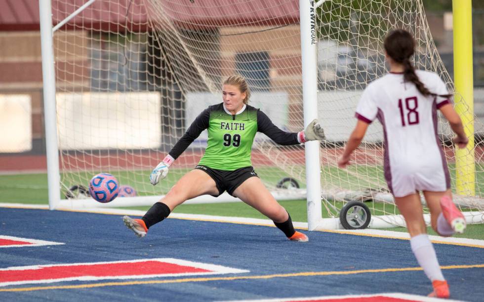 Faith Lutheran goalkeeper Olivia Petty (99) attempts to block a wide shot during the high schoo ...