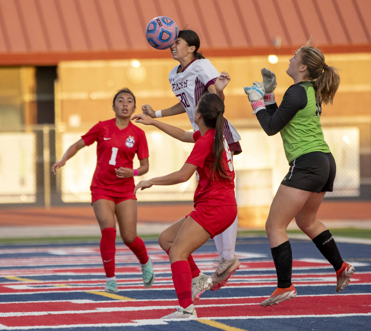 Faith Lutheran defender Jordyn Staggs (30) headbutts the ball during the high school soccer gam ...