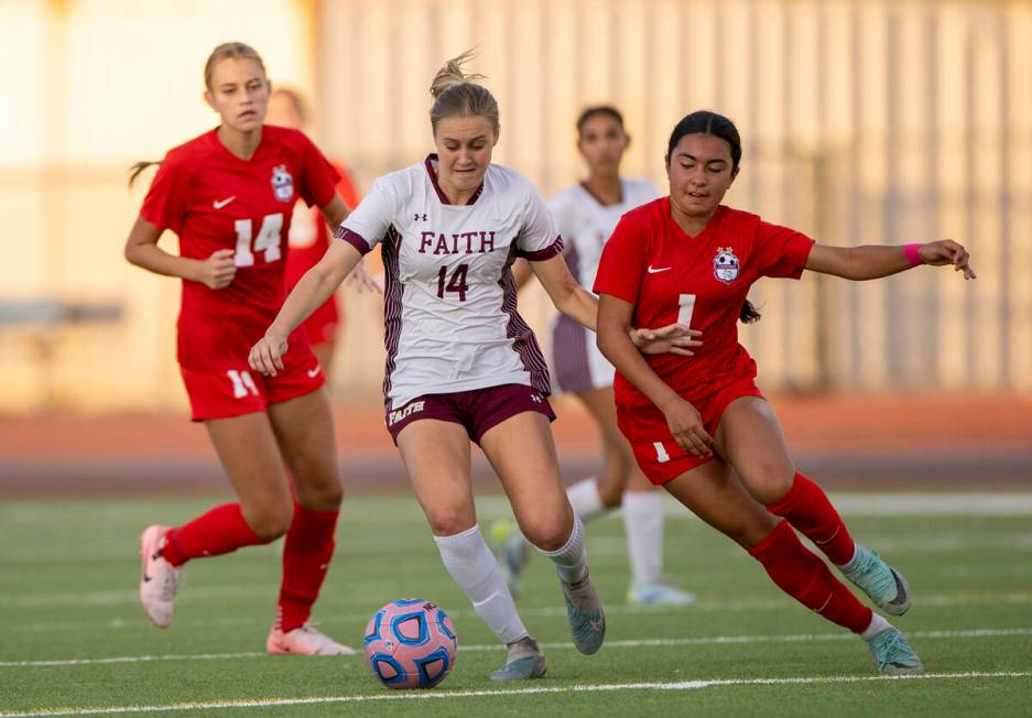 Faith Lutheran defender Kloe Abdalla (14) and Coronado forward Taylor Takahashi (1) compete for ...