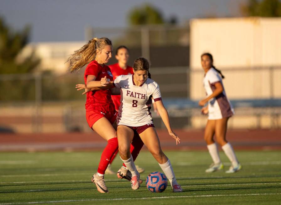 Faith Lutheran forward Olivia Stark (8) attempts to keep the ball from Coronado midfielder Alex ...