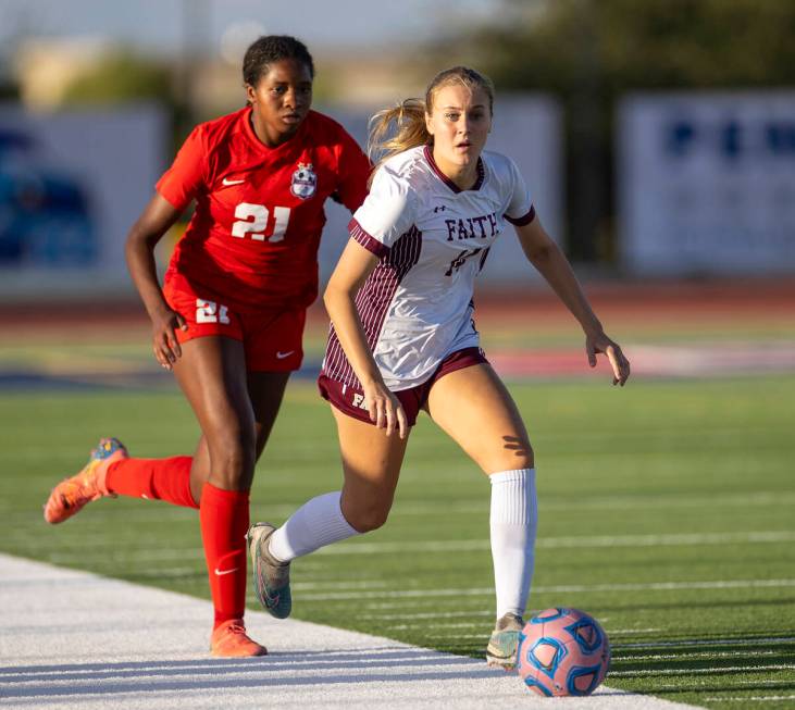 Faith Lutheran defender Kloe Abdalla (14) kicks the ball away from Coronado forward Jazmine Mcc ...