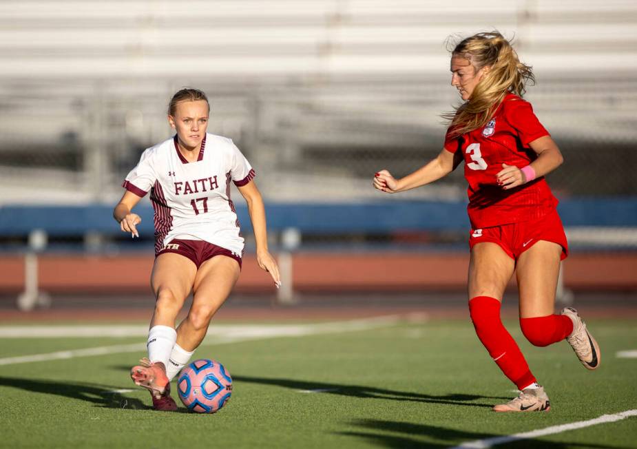 Faith Lutheran sophomore Julia Anfinson (17) passes the ball during the high school soccer game ...