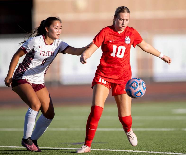 Coronado midfielder Ryan Neel (10) and Faith Lutheran midfielder Ana Coe (11) compete for the b ...