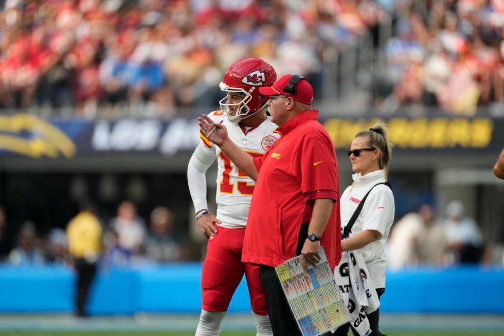 Kansas City Chiefs quarterback Patrick Mahomes, left, talks with head coach Andy Reid during th ...