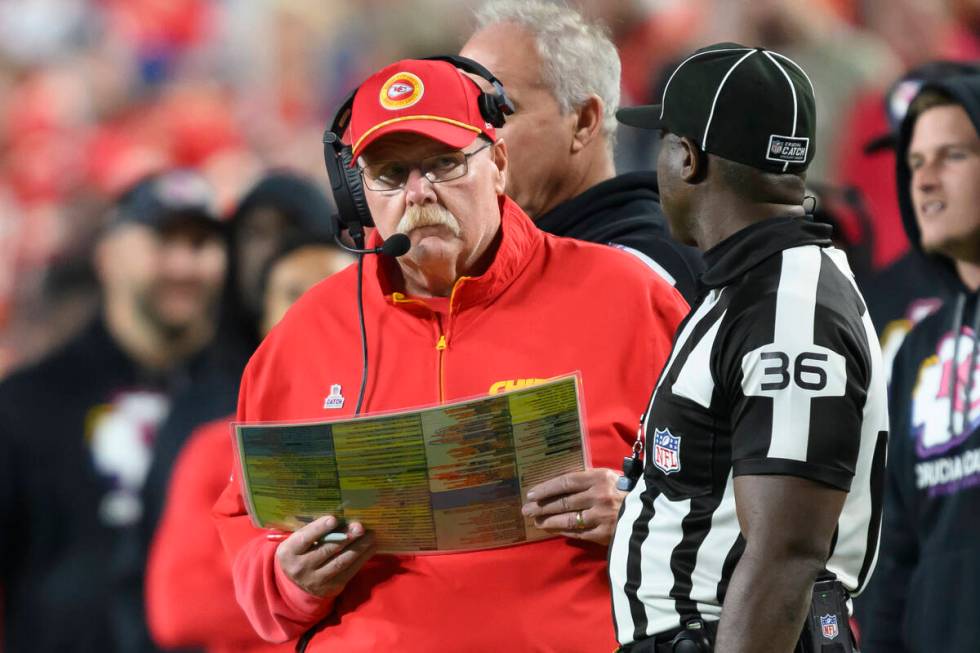 Kansas City Chiefs head coach Andy Reid, left, talks to field judge Anthony Jeffries (36) while ...