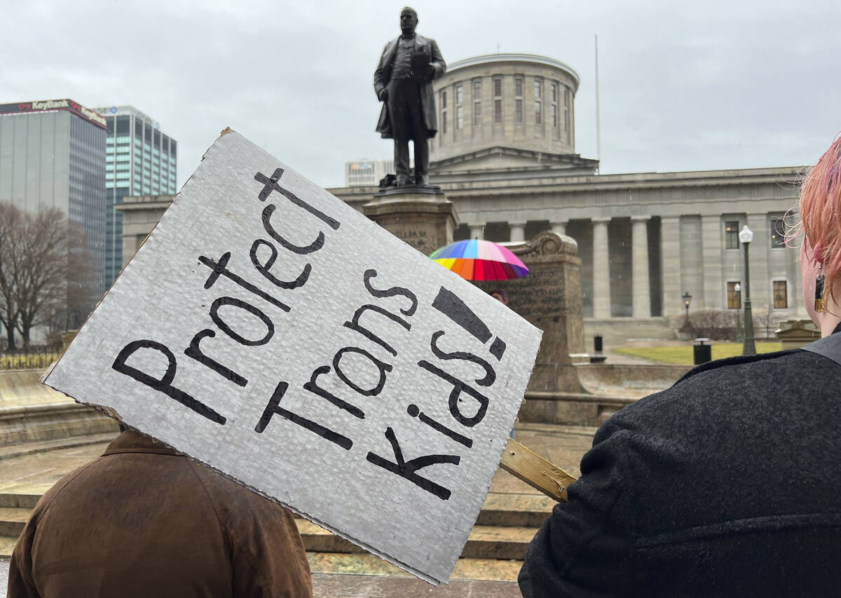 Protesters advocating for transgender rights and healthcare stand outside of the Ohio Statehous ...