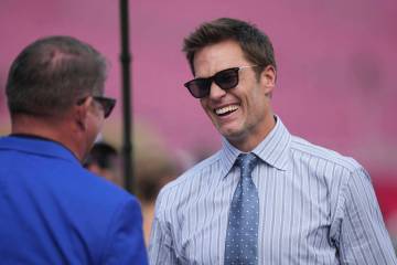 Former NFL quarterback Tom Brady visits on the field before an NFL football game against the Ph ...