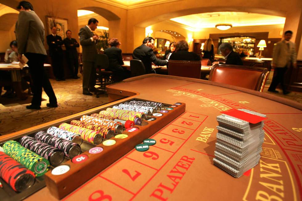 Chips and cards are shown on a baccarat table in the high-roller VIP baccarat room at the MGM G ...