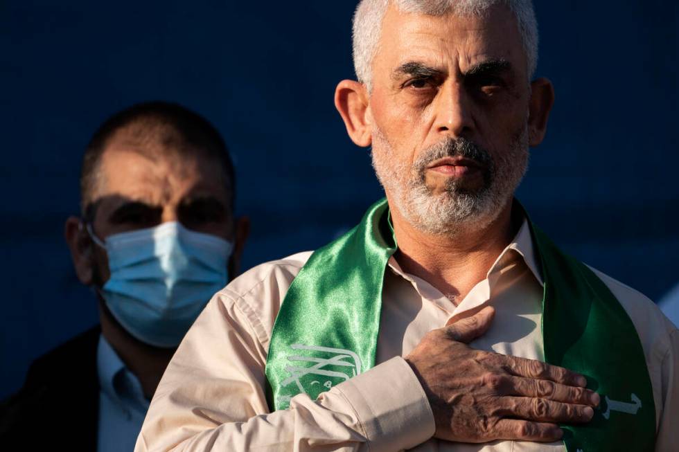 FILE - Yahya Sinwar, Palestinian leader of Hamas in the Gaza Strip, places his hand over his he ...