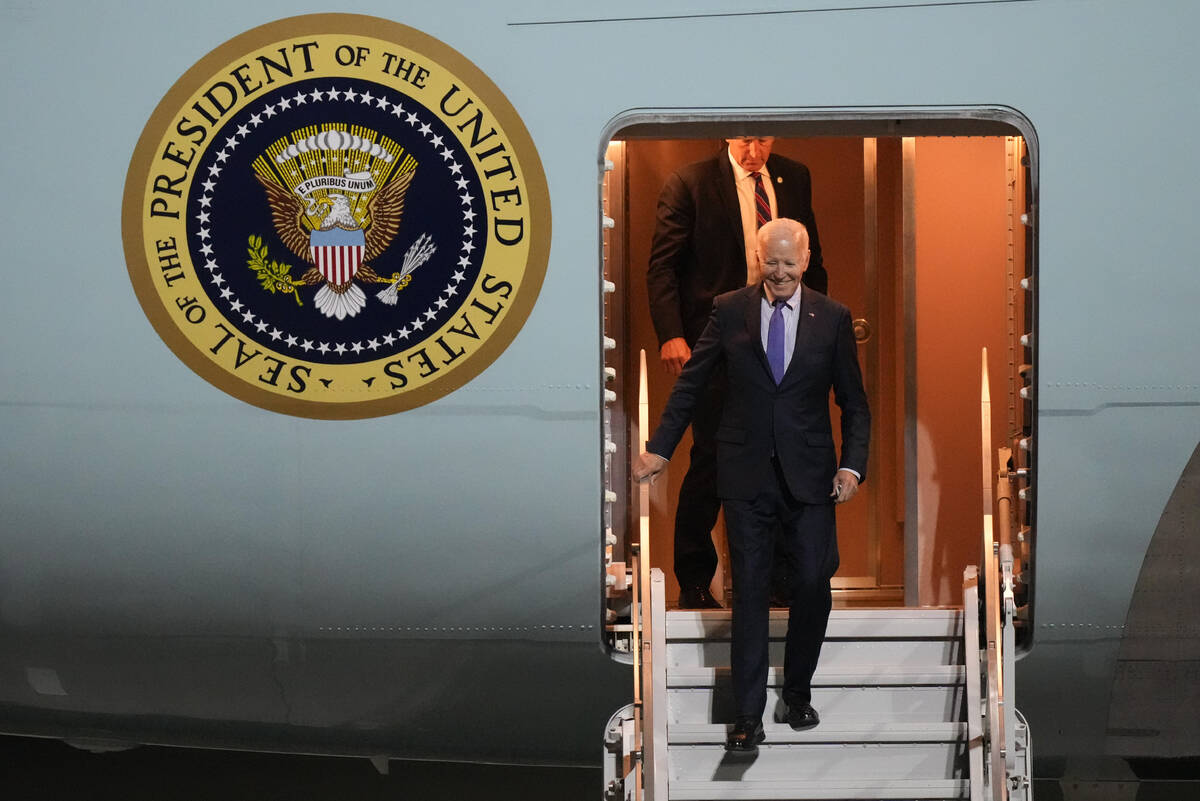 President Joe Biden walks down the stairs of Air Force One as he arrives at Brandenburg Airport ...