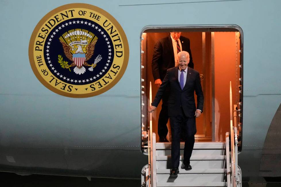 President Joe Biden walks down the stairs of Air Force One as he arrives at Brandenburg Airport ...