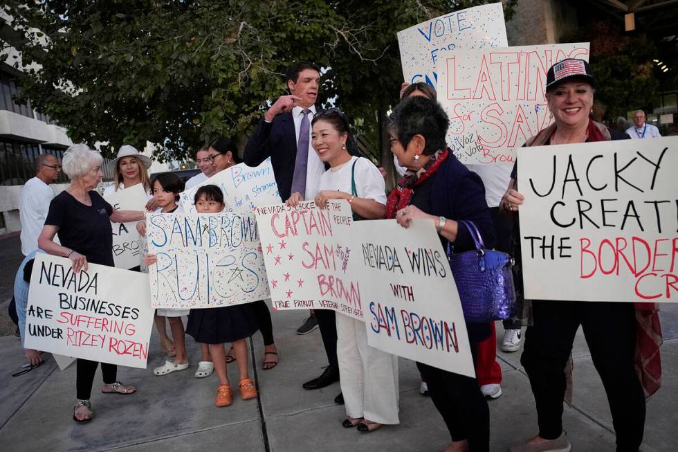 Republican Senate candidate Sam Brown, center, meets with supporters before a debate against Se ...