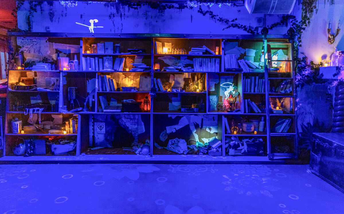 Animated characters and imagery are projected on the walls and bookcase in a scene at Particle ...