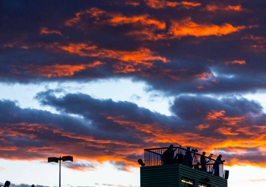 The sky is brilliant at sunset as Green Valley faces Faith Lutheran for the first half of their ...