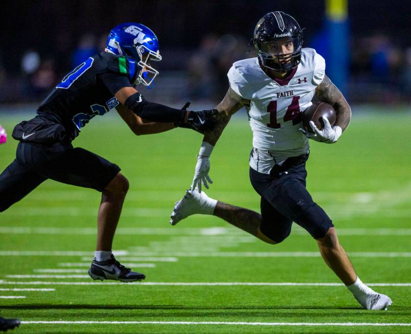 Green Valley cornerback Jerome Kosloske (20) attempts top stop Faith Lutheran running back Cale ...