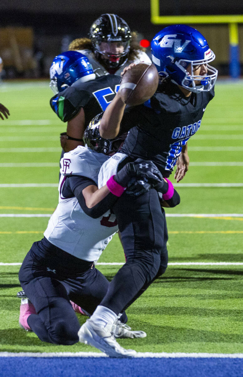 Green Valley quarterback Michael Lewis (15) is sacked for a safety by Faith Lutheran linebacke ...