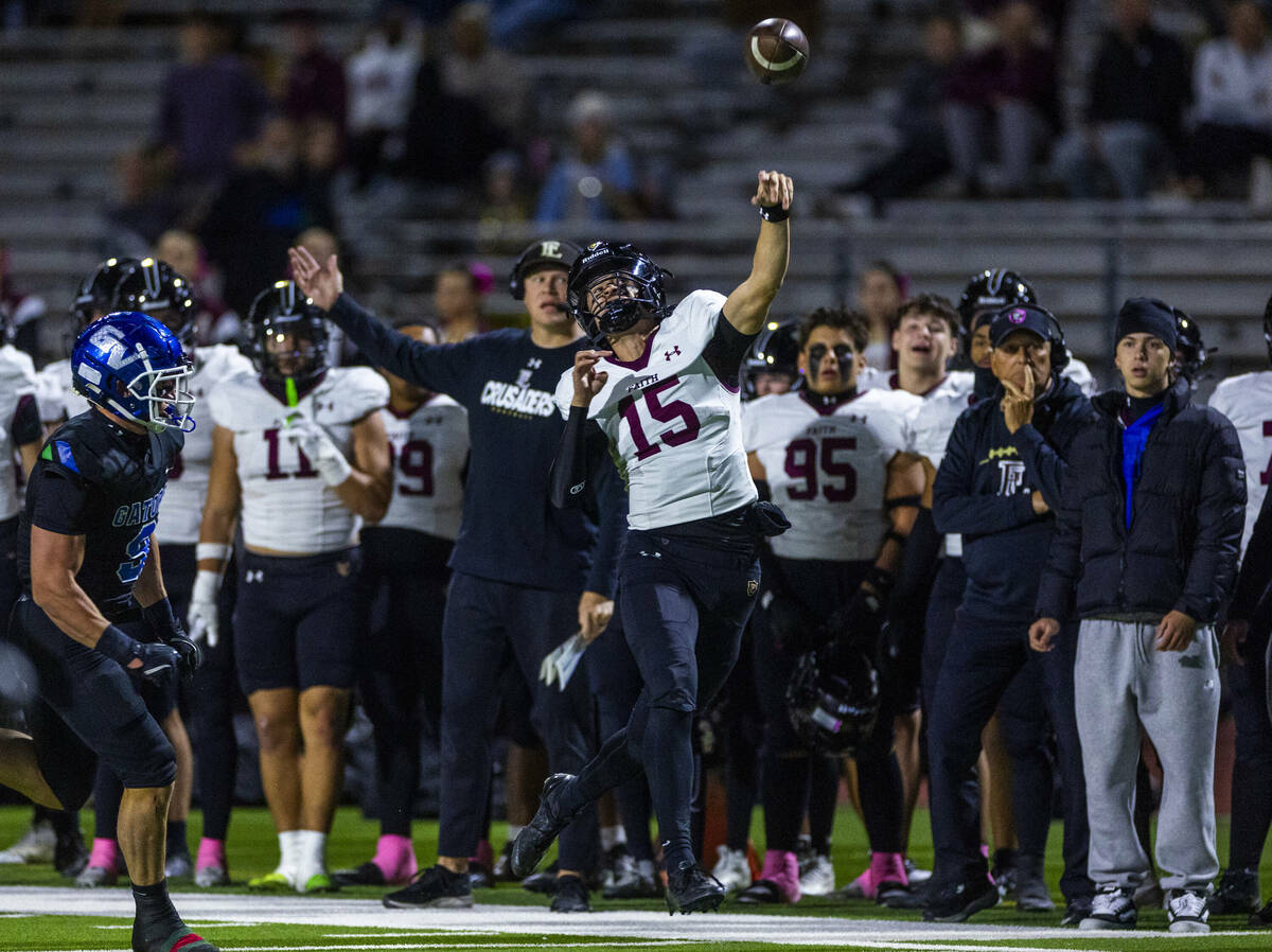 Faith Lutheran quarterback Alexander Rogers (15) releases a pass on the run along the sidelines ...