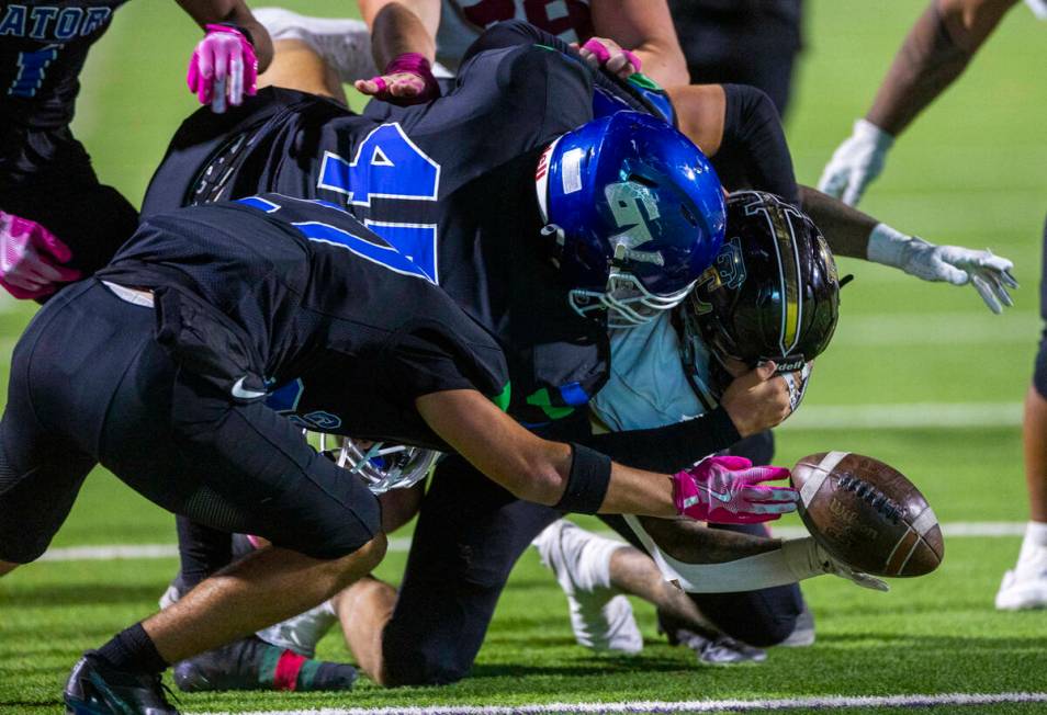 Faith Lutheran running back Patrick Duffy (11) fumbles the ball with a strip by Green Valley li ...