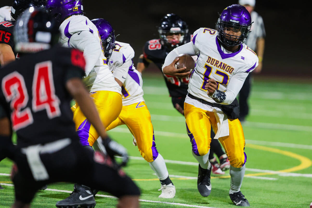 Durango quarterback Alexander Mercurius (12) runs the ball during a high school football game b ...