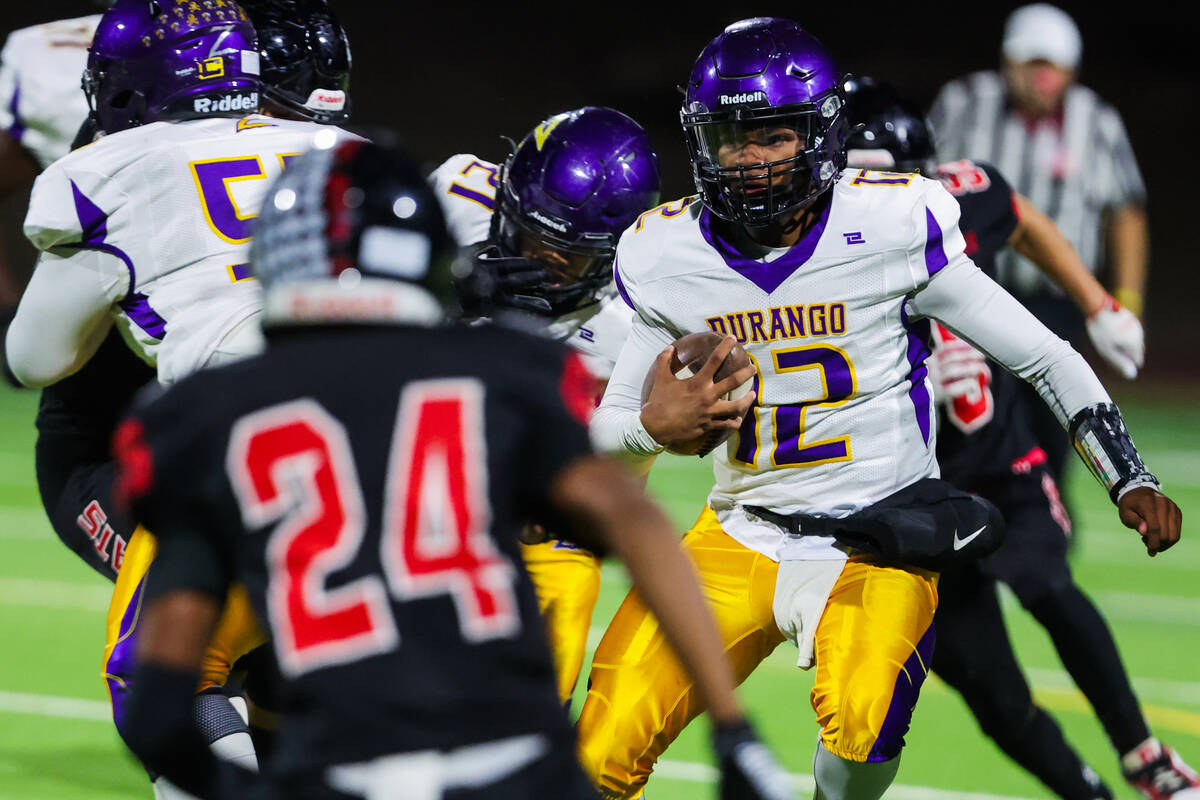 Durango quarterback Alexander Mercurius (12) runs the ball during a high school football game b ...