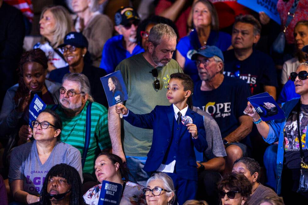 A youngster proudly holds a sign as Former President Barack Obama speaks on behalf of the Harri ...