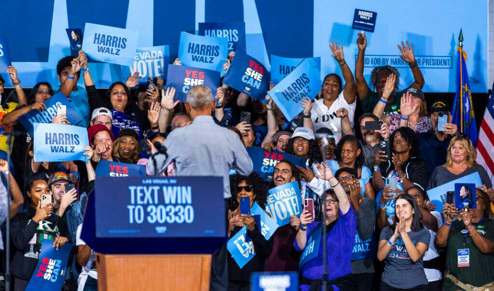 Former President Barack Obama greets the crowd behind him as he speaks on behalf of the Harris- ...