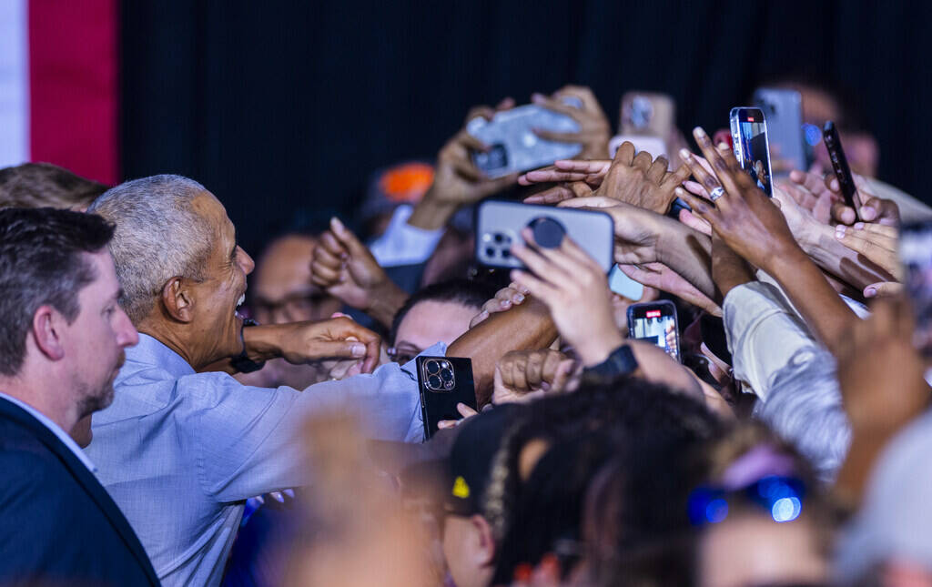 Former President Barack Obama shakes hands with the crowd after speaking on behalf of the Harri ...