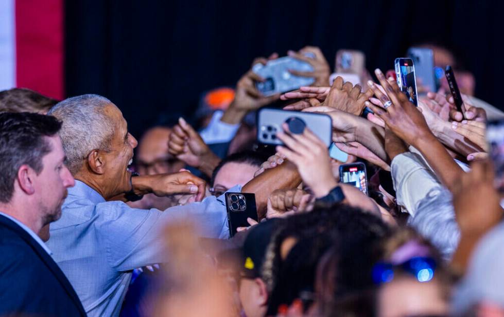 Former President Barack Obama shakes hands with the crowd after speaking on behalf of the Harri ...