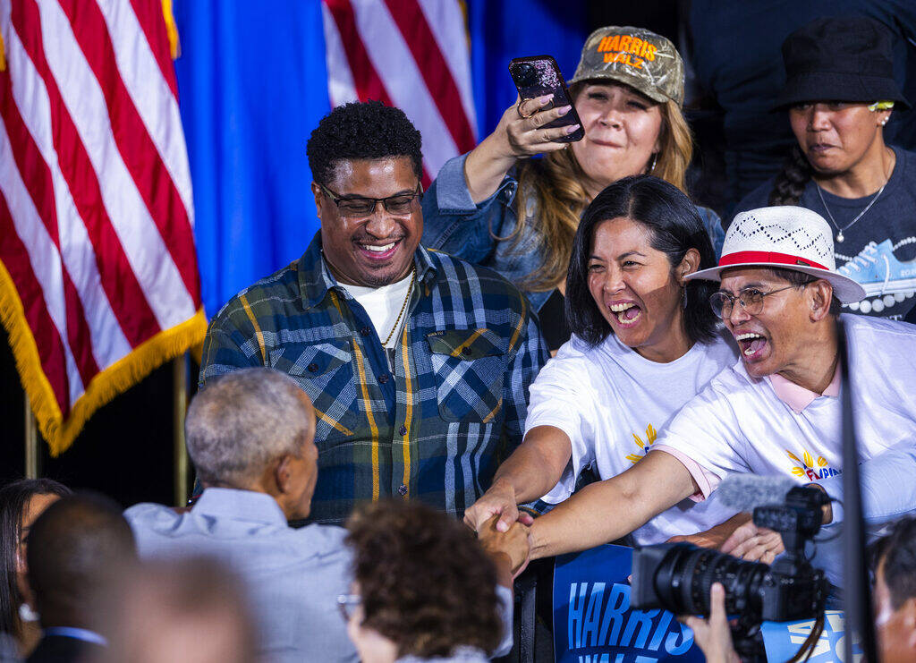 Former President Barack Obama greets members of the crowd after speaking on behalf of the Harri ...