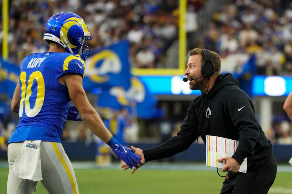 Los Angeles Rams wide receiver Cooper Kupp (10) celebrates a touchdown with head coach Sean McV ...