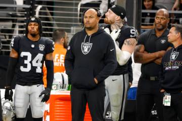 Raiders head coach Antonio Pierce and defensive end Maxx Crosby (98) safety Thomas Harper (34) ...