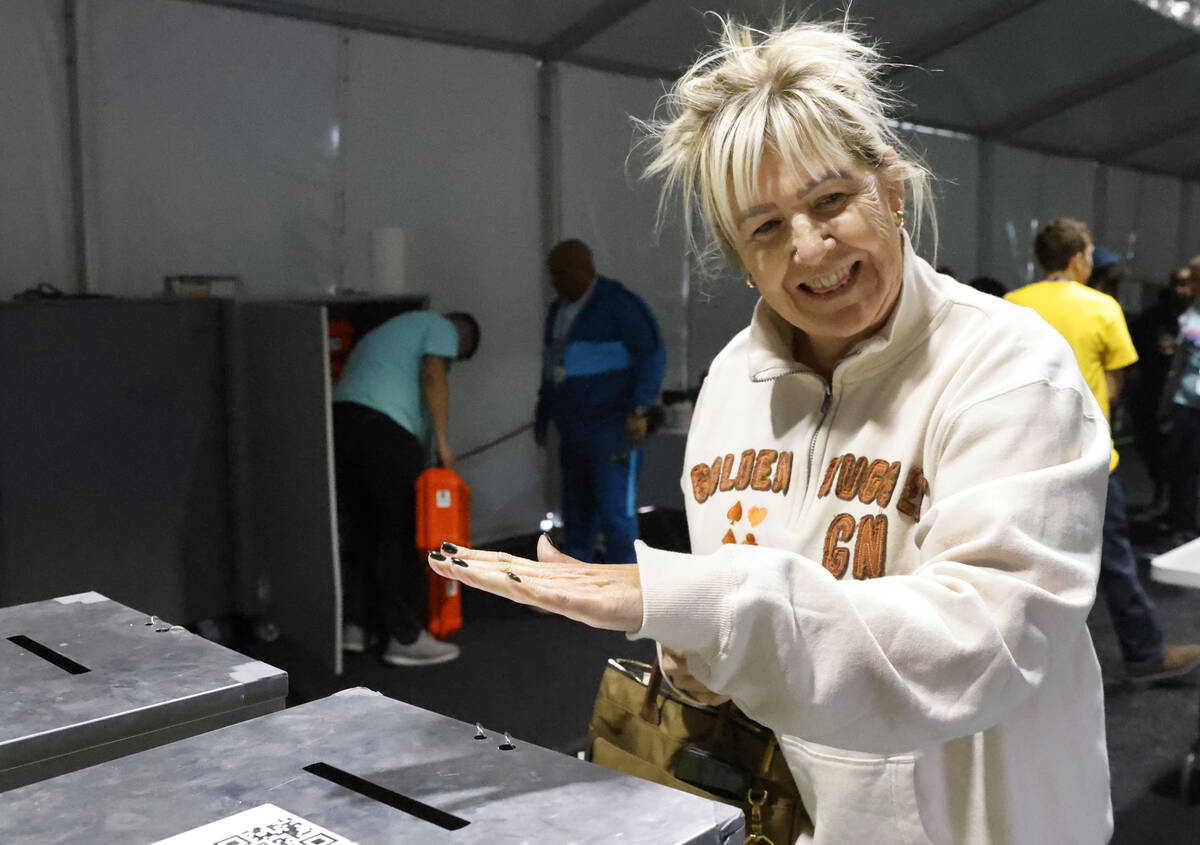 Pauline Shackelford reacts after dropping her ballots in an official mail-in ballot drop box du ...