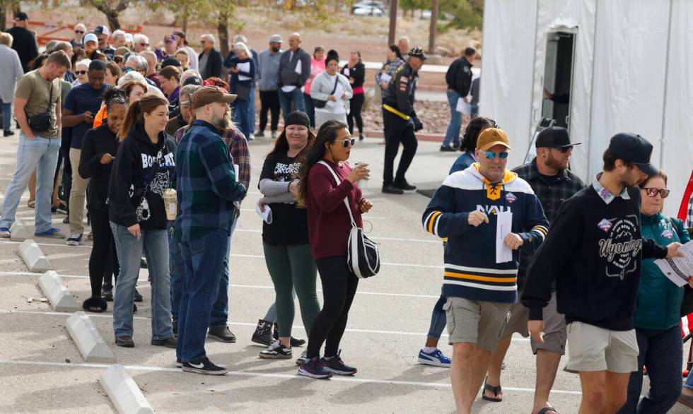 People line up to cast their vote during early voting at Thunderbird Family Sports Complex, on ...