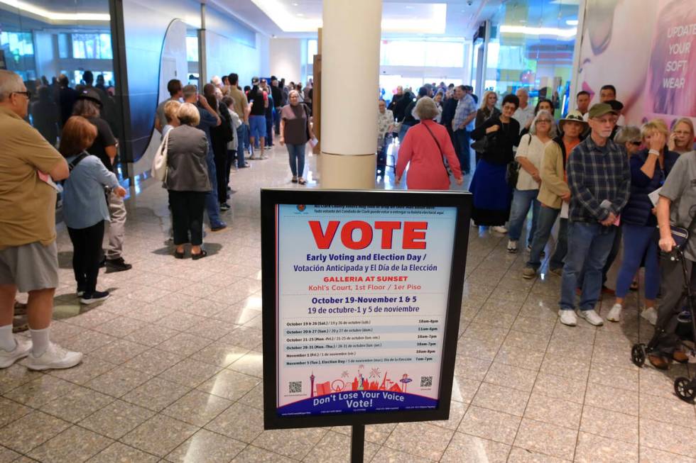 Hundreds of voters stand in line at the Galleria Mall to take part in early voting Saturday, Oc ...