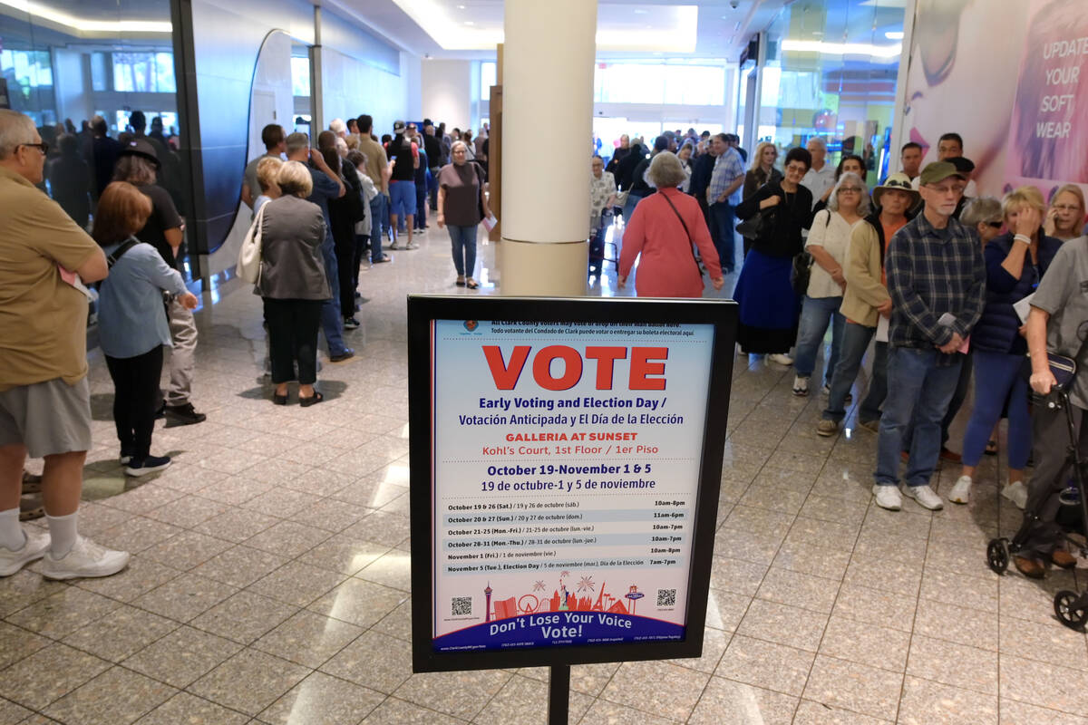 Hundreds of voters stand in line at the Galleria Mall to take part in early voting Saturday, Oc ...