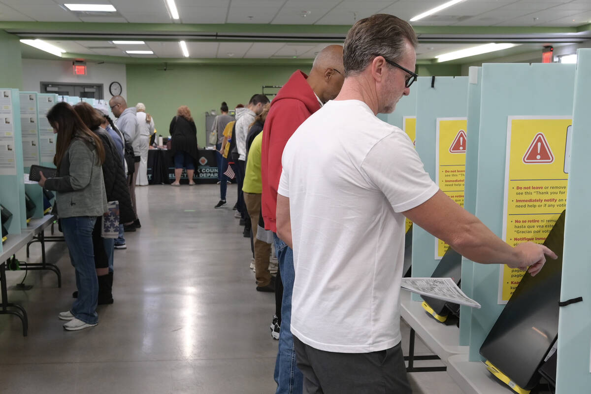 Voters cast their ballots at the Silverado Ranch Community Center during the first day of early ...