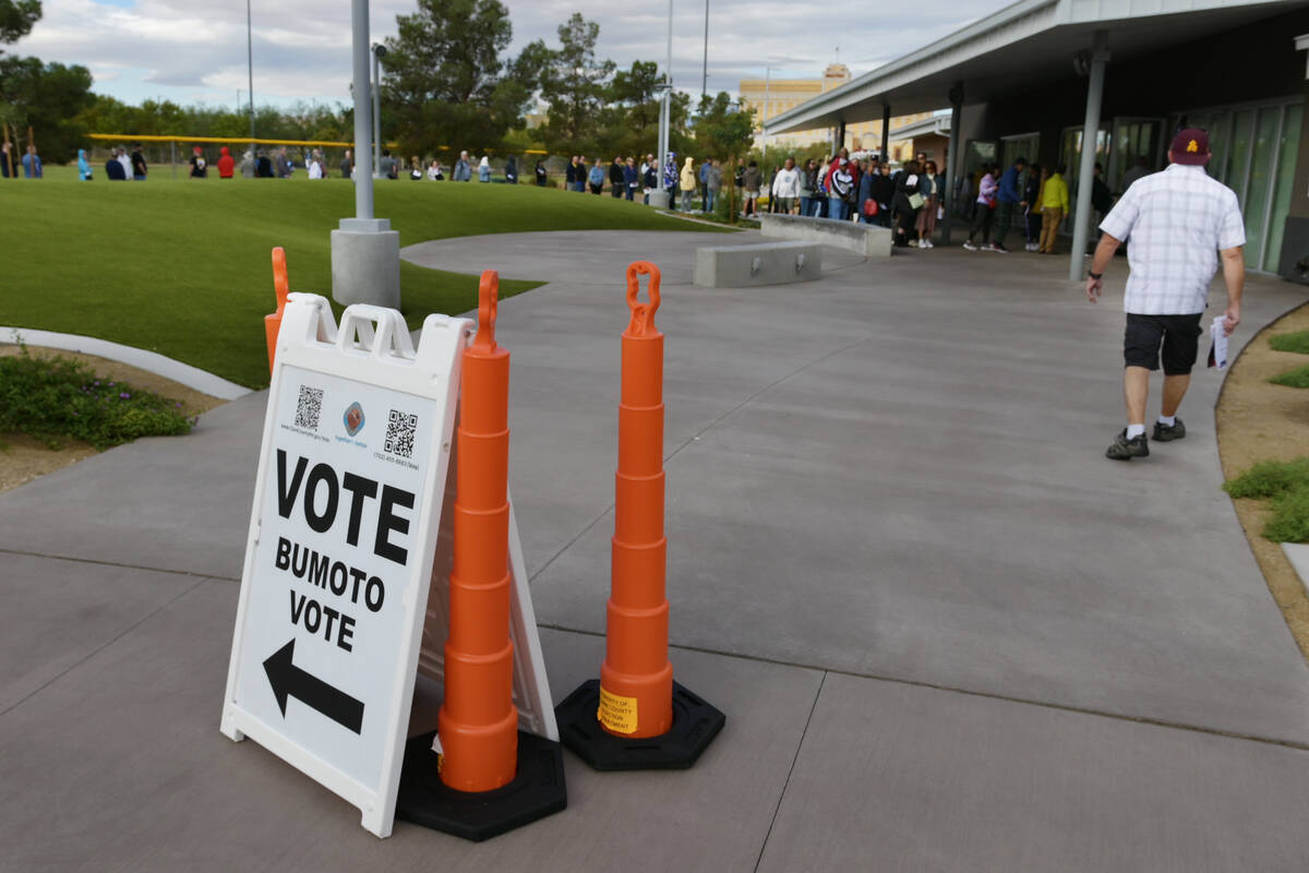 Voters line up outside the Silverado Ranch Community Center to take part in early voting Saturd ...